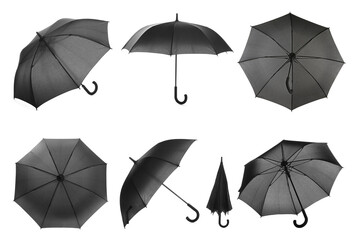 Set with stylish black umbrellas on white background