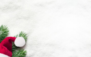 Fototapeta na wymiar Santa hat with fir branch on snow. Christmas background