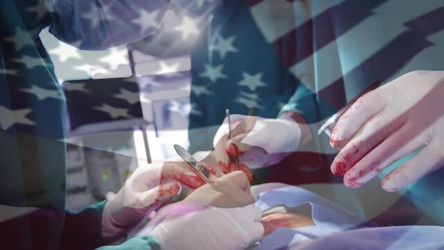 Animation of flag of usa waving over surgeons in operating theatre