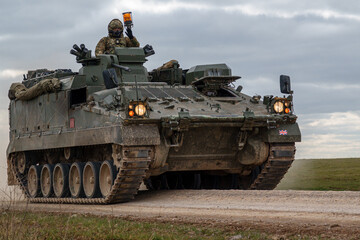 British army Warrior FV512 mechanized recovery vehicle tank in action on military exercise,...