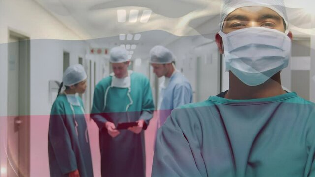 Animation of flag of russia waving over surgeons in operating theatre