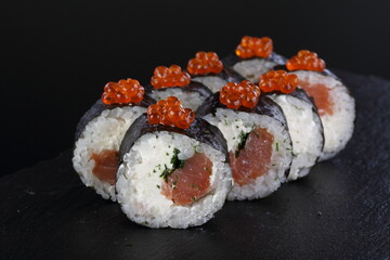 sushi on a black plate