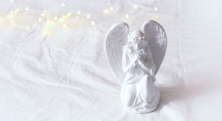  angel on white background with lights bokeh. faith in God, Christianity, memory, religion concept. symbol of orthodoxy, Lent, Easter,Christmas, church holiday