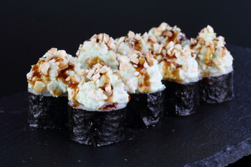 sushi on a black plate