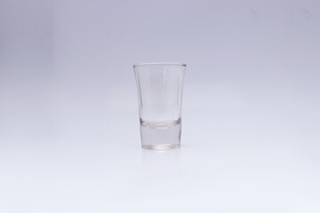 Empty ouzo glass isolated on white background