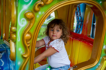 little child on carousel