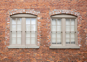 old brick wall with symmetrical windows
