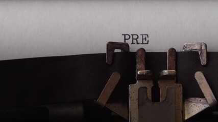 Typing phrase Press Release on retro typewriter. Close up.