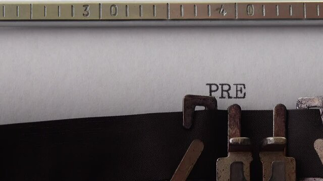 Typing phrase Press Release on retro typewriter. Close up.