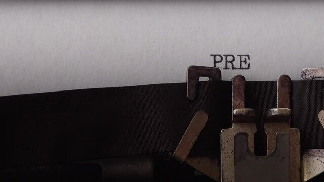 Typing phrase Press Release on retro typewriter. Close up.