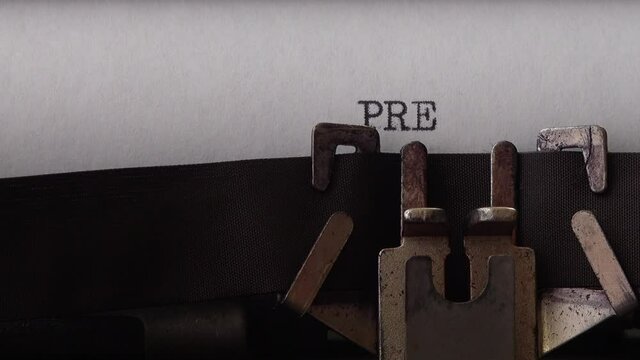 Typing phrase Press Release on retro typewriter. Close up.