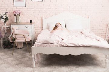 Fototapeta na wymiar Attractive woman sleeping on bed in bedroom. ....