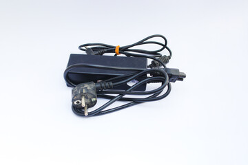 Old used laptop charger isolated on white background.