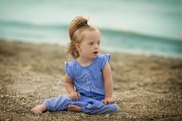 beautiful girl with Down syndrome on the beach
