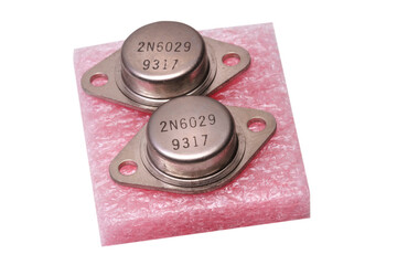 2 metal transistors with encapsulation type TO-3 on antistatic base and white background