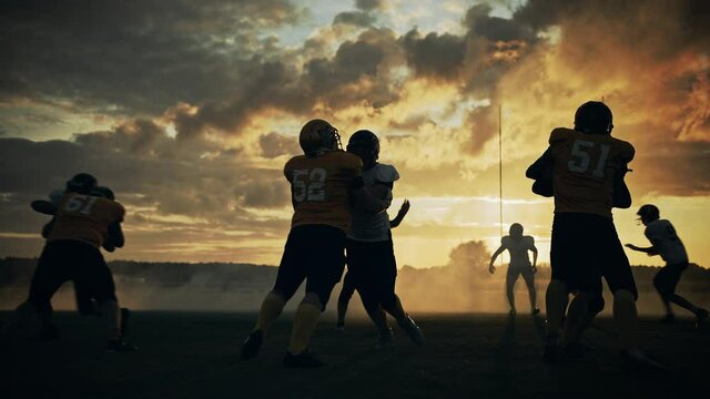 American Football Field Two Teams Compete: Players Pass and Run Attacking to Score Touchdown Points. Professional Athletes Fight for the Ball, Tackle. Cinematic Slow Motion, Golden Hour Sunset