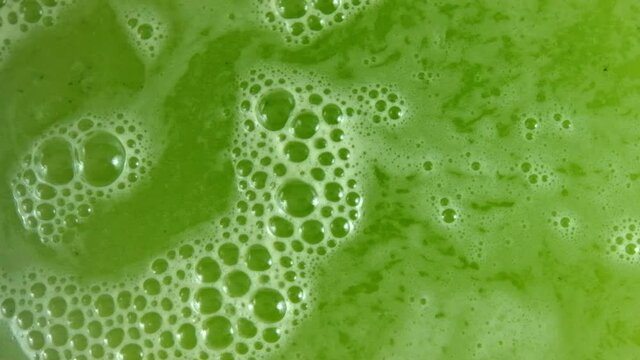 Top view of fresh and bubbly green juice