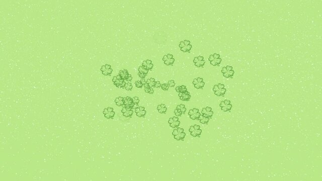 Animation of snow falling over green clover leaves on green background