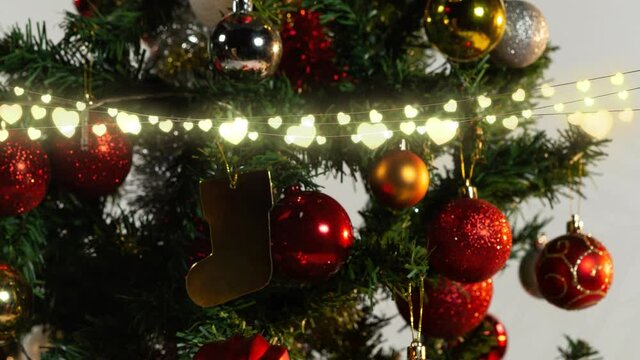 Animation of glowing fairy lights and christmas tree decorations