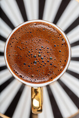 Turkish Coffee on wood table. Turkish Coffee ceramic traditional cup, coffee beans scattered on table.