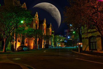 Fototapeta na wymiar Big moon over buildings sandstone