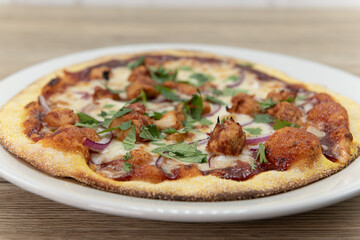 Personal sized pizza with equal meat and vegetable toppings of olives, peperoni, sausage, and onions with a crispy crust
