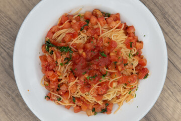 Overhead view of chicken breast smothered in creamy marsala sauce served over pasta spaghetti for a very hearty Italian meal