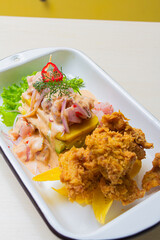 Causa acevichada with fried fish.