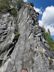 View from the water on the steep slope of the flooded Marble Canyon in the Ruskeala Mountain Park on a sunny summer day.