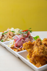 Trios of typical Peruvian dishes, such as ceviche, arroz con pato, papa huancaina and others.