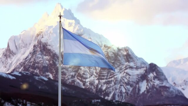 Flag of Argentina and the Distinctive, Sharp triangle-shaped Mountain called Monte Olivia (Mount Olivia), in Ushuaia, Tierra del Fuego Province, Argentina. 4K.