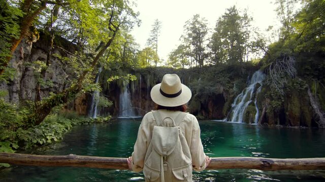 Attractive girl near waterfalls in Plitvice National Park