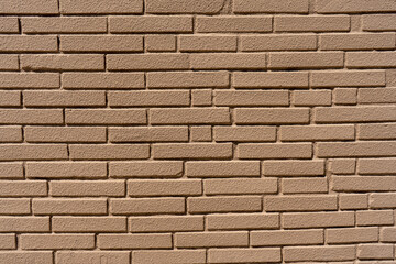 Clean, freshly painted, tan, generic, brick cinder block wall background.