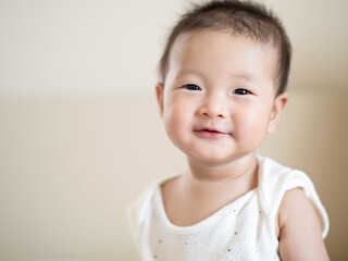 Close up adorable Asian cute infant baby  sitting with happiness smiling , a sweet healthy baby infant concept