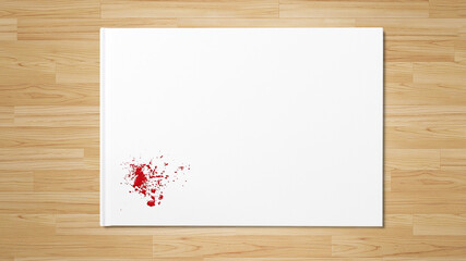Red ink splash on white paper on wooden table with space for copy space