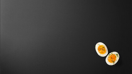 Boiled egg with spices on black background with copy space free image