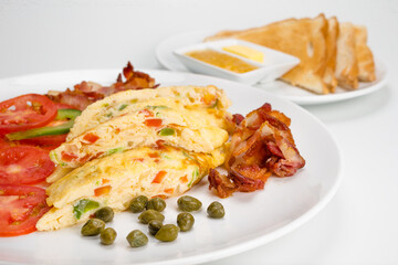 Omelette with Bacon Slices. Omelette with Bacon Slices stack and vegetables, fruit salad, Toast and cup of coffee, isolated On White Background
