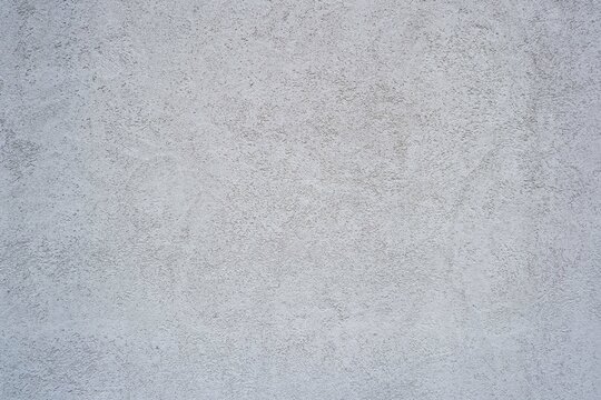 Simple white rough plaster wall for background. White surface. white wall materials.