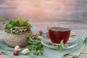 Tea with mint and rose hips and black currants in a transparent bowl. Antioxidants, vitamins, healthy food.