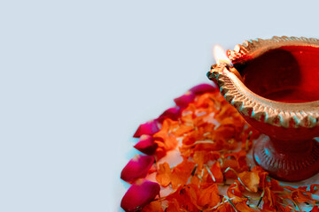 beautiful Diya in on flowerbed for Diwali and Deepawali