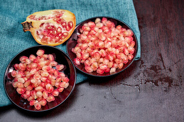 closeup ripe pomegranate fruit and seeds on a plate