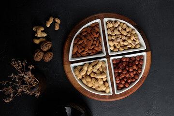 Nuts sprinkled in plates, hazelnuts, almonds, pistachios, peanuts