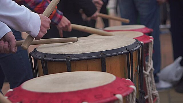 Closeup of hands playing snare drum in drumline in slow motion