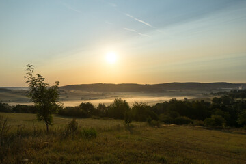 Fototapeta na wymiar Sunrise with fog at the german Rothaargebirge