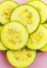 Top view of a plate with zucchini, which were cut into round slices