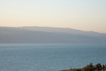 Sunrise over the Dead Sea on a foggy day. A view from Israel To Jordan Mountains. High quality photo
