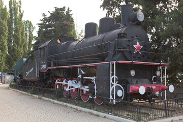 Fototapeta na wymiar Monument to the armored train Zheleznyakov - the El-2500 steam locomotive and the TM-1-180 railway artillery mount near the Sevastopol railway station, Crimea