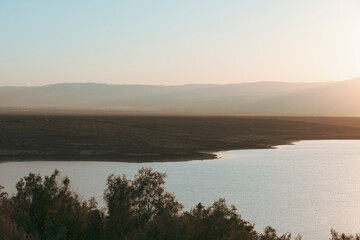 Fototapeta na wymiar Sunrise over the Dead Sea on a foggy day. A view from Israel To Jordan Mountains. High quality photo