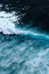 Obraz premium Aerial view to seething waves with foam. Waves of the sea meet each other during high tide and low tide