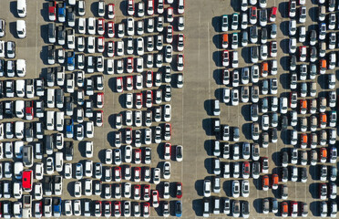 Aerial view from drone to automobile customs terminal. Large number of cars at customs terminal are awaiting shipment. Accumulative customs platform for cars.